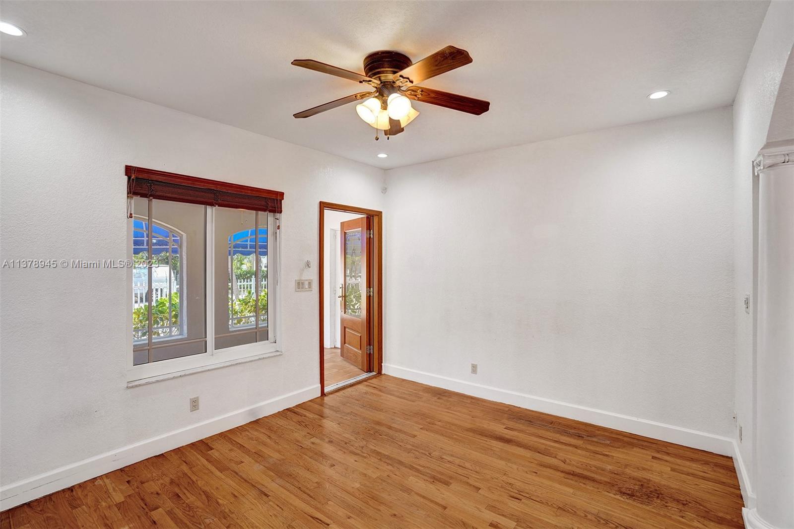 2231 Southwest 17th Street Miami, FL 33145 - Photo 23 of 69 a view of an empty room with window and wooden floor