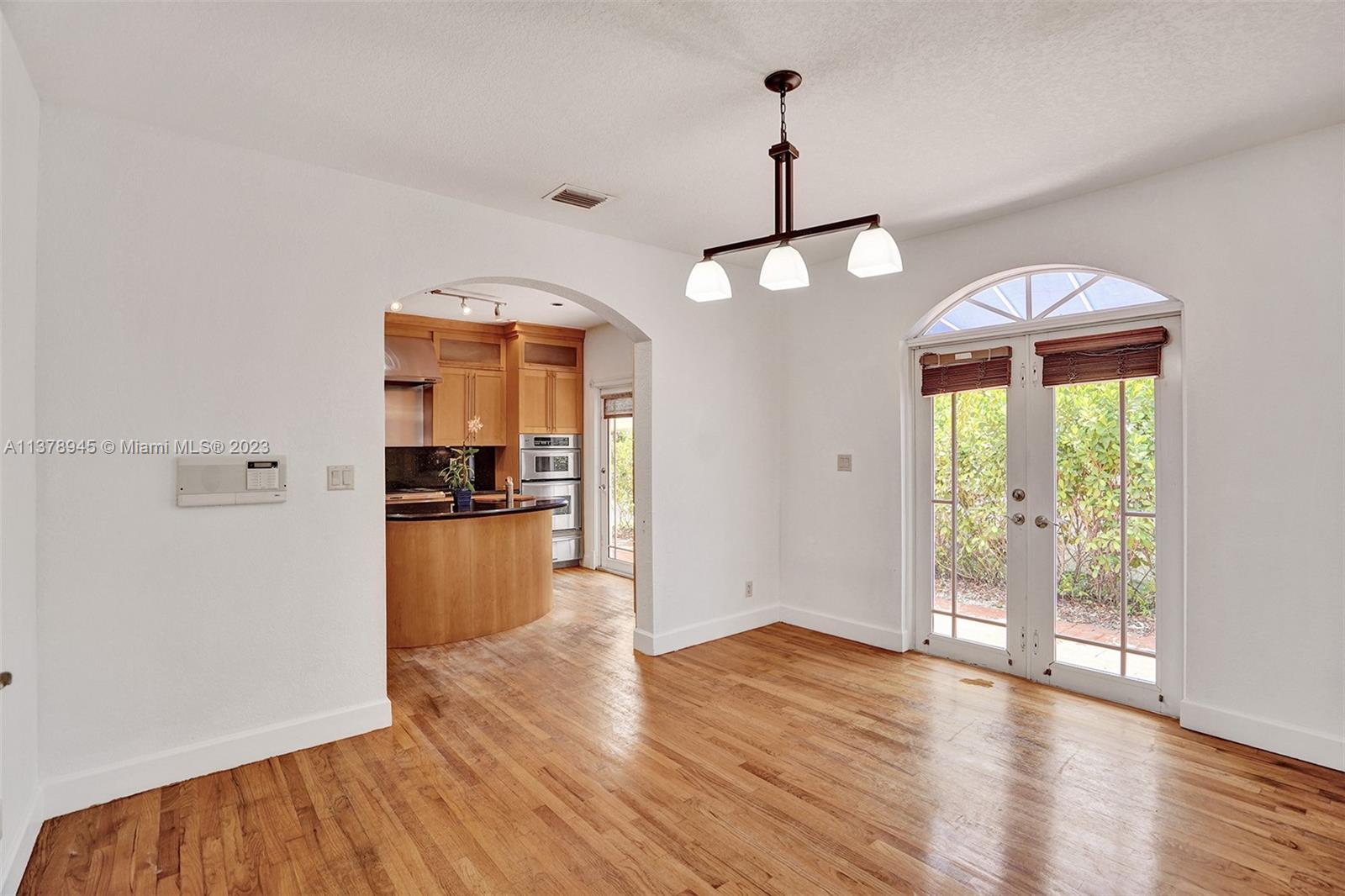 2231 Southwest 17th Street Miami, FL 33145 - Photo 24 of 69 a view of a room with wooden floor a ceiling fan and windows