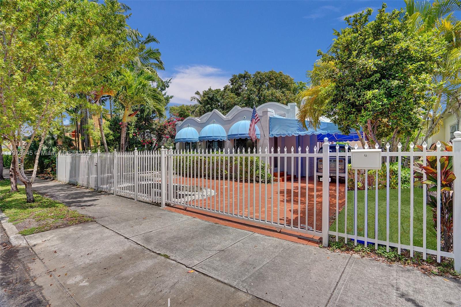 2231 Southwest 17th Street Miami, FL 33145 - Photo 3 of 69 a view of a house with a small yard and wooden fence