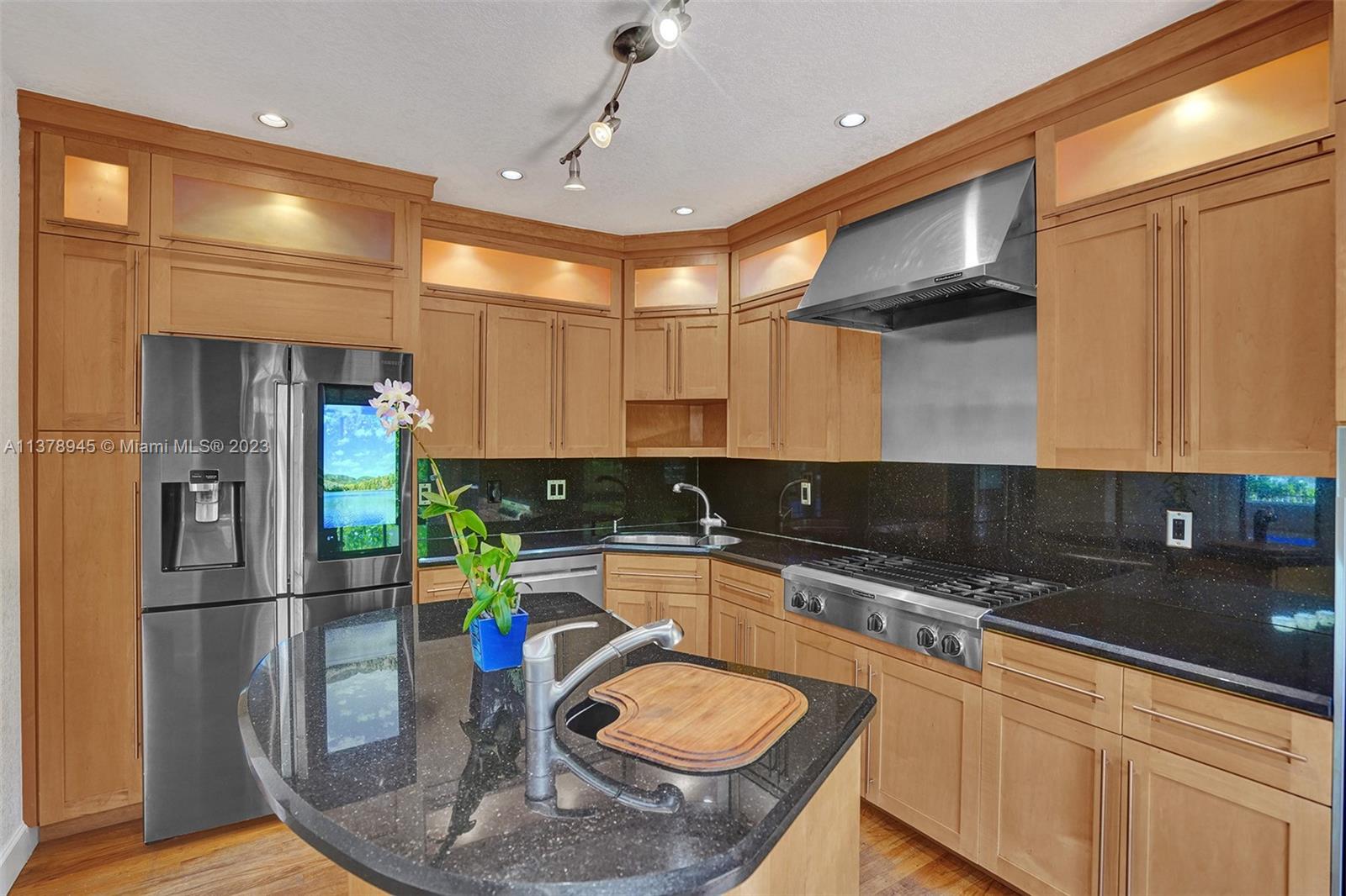 2231 Southwest 17th Street Miami, FL 33145 - Photo 32 of 69 a kitchen with stainless steel appliances granite countertop a sink a refrigerator and a stove top oven