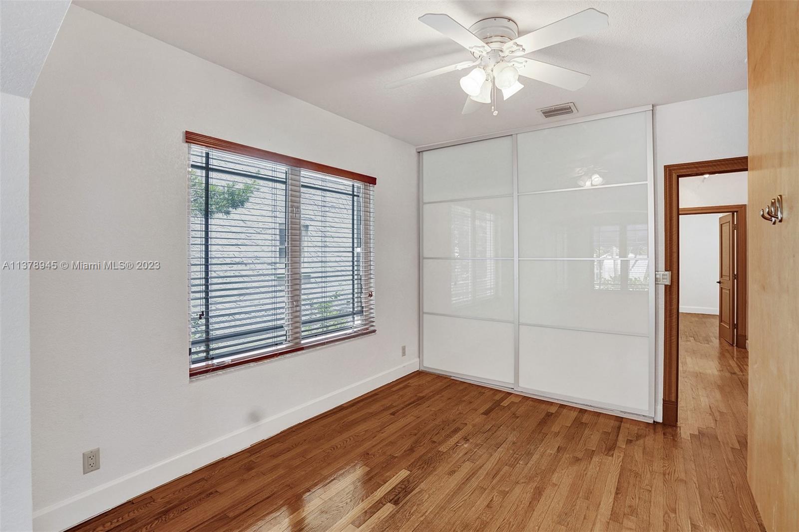 2231 Southwest 17th Street Miami, FL 33145 - Photo 39 of 69 an empty room with wooden floor and a window