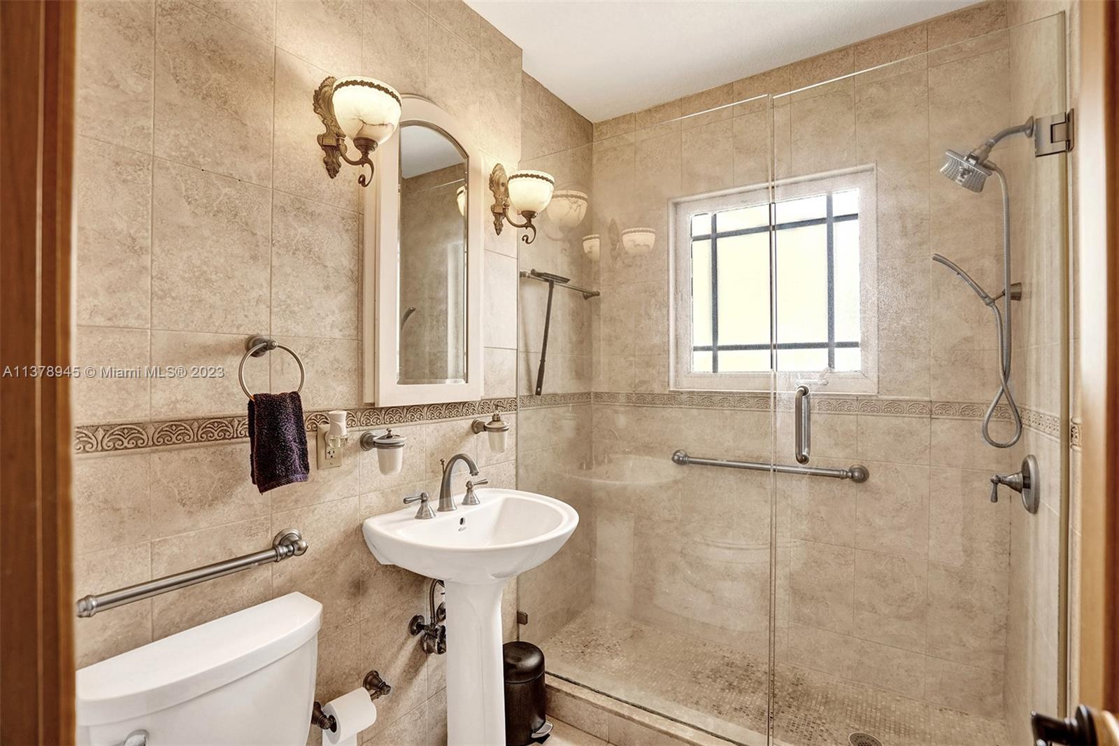2231 Southwest 17th Street Miami, FL 33145 - Photo 45 of 69 a bathroom with a sink and mirror with shower