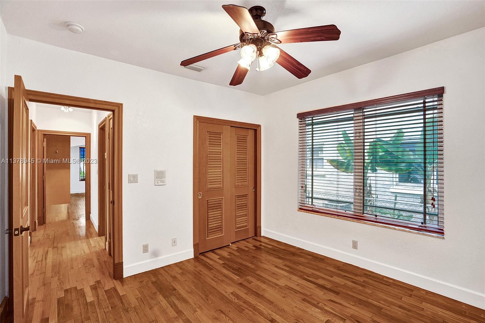 2231 Southwest 17th Street Miami, FL 33145 - Photo 47 of 69 a view of an empty room with wooden floor and a window