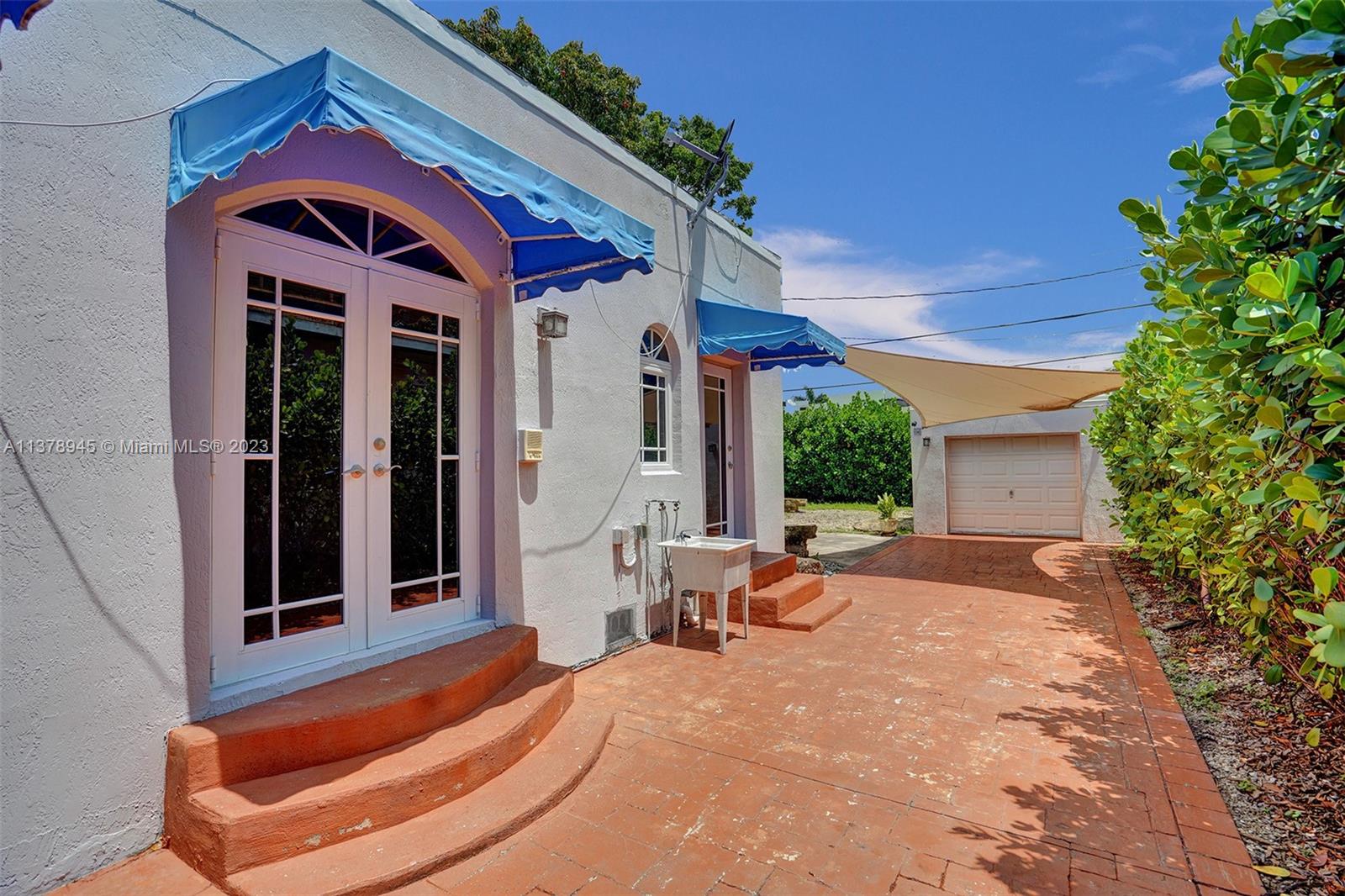 2231 Southwest 17th Street Miami, FL 33145 - Photo 8 of 69 a front view of a house with a yard