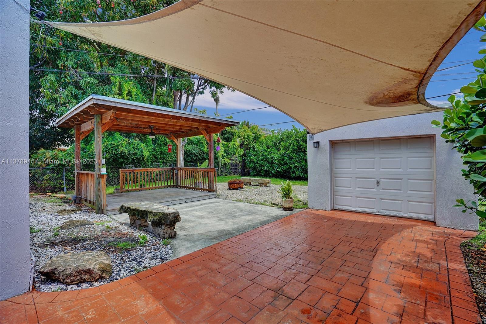 2231 Southwest 17th Street Miami, FL 33145 - Photo 9 of 69 a backyard of a house with large trees and barbeque oven