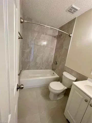 a white toilet sitting next to a bathroom sink