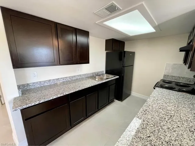 a kitchen with a refrigerator and a sink