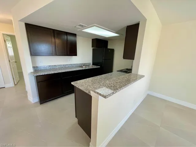 a kitchen with a sink and a refrigerator