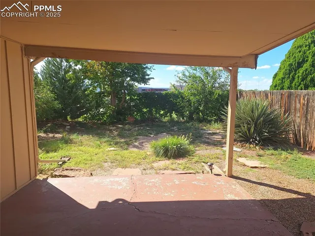 a view of a floor to ceiling window and a yard