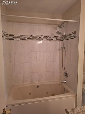 a bathroom with a shower and a bath tub