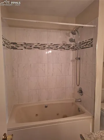 a bathroom with a shower and a bath tub