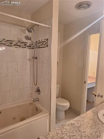 a bathroom with a shower a bathtub and a toilet