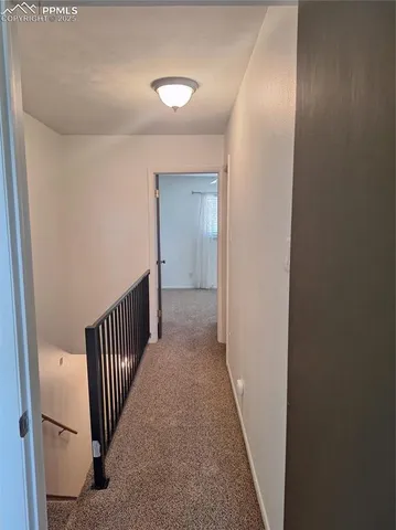 a view of a hallway with wooden floor and entryway