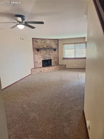 a view of an empty room with a fireplace