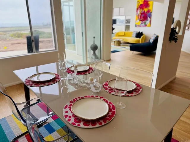a dining room with furniture and wooden floor