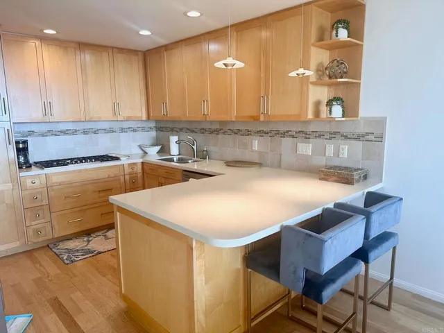 a kitchen with a sink cabinets and wooden floor