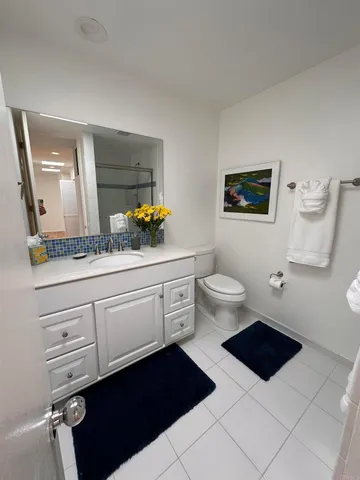 a bathroom with a toilet a sink and a mirror