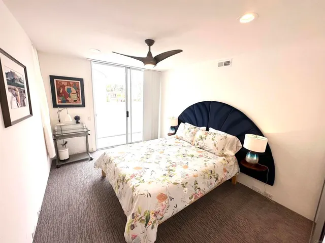 a bedroom with a bed and a painting on the wall