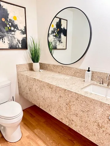 a bathroom with a toilet a sink and a mirror