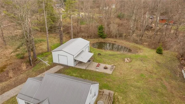 an aerial view of residential house with outdoor space and parking