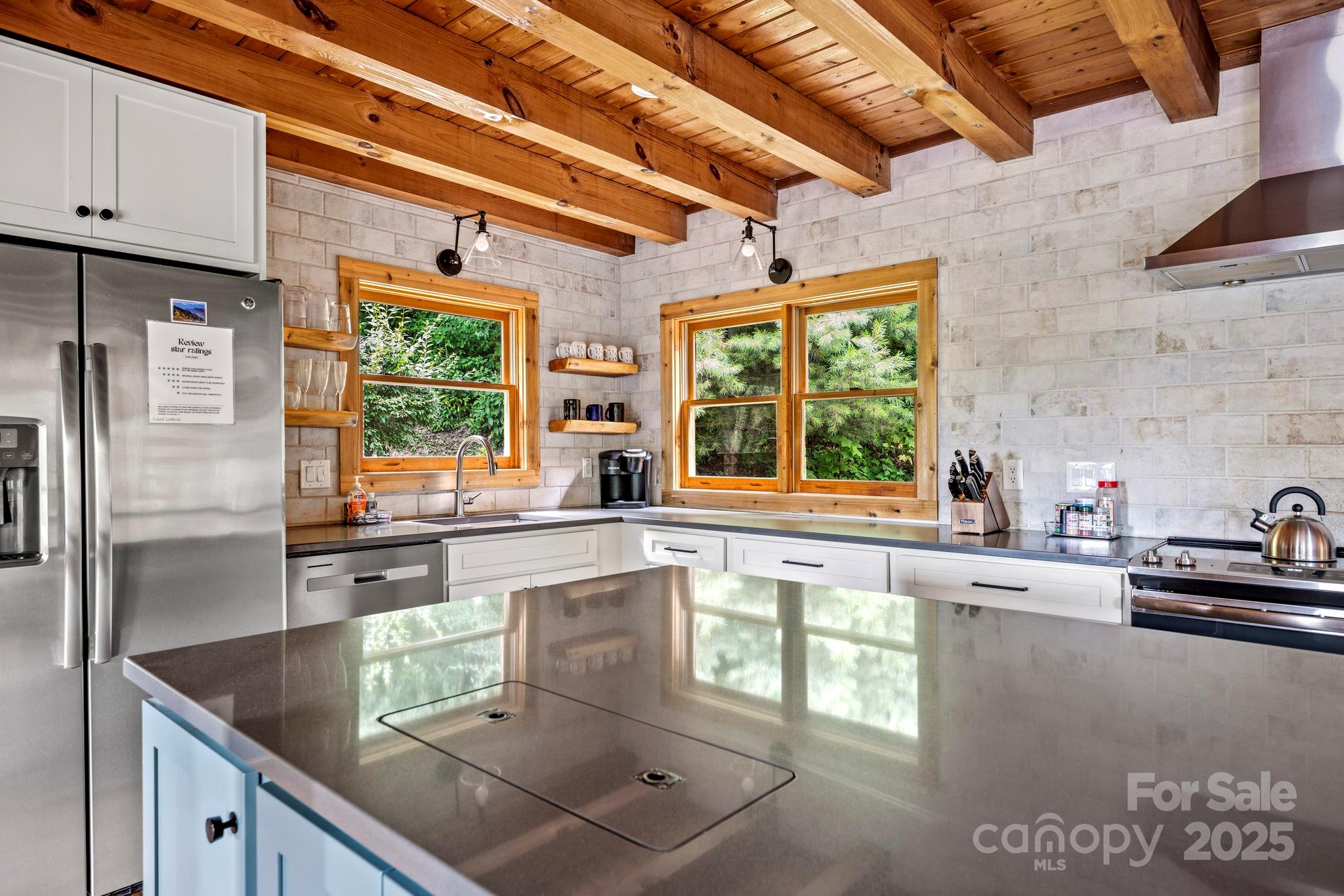 1933 Laurel Ridge North Maggie Valley, NC 28751 - Photo 14 of 45 a kitchen with stainless steel appliances granite countertop a sink window and cabinets
