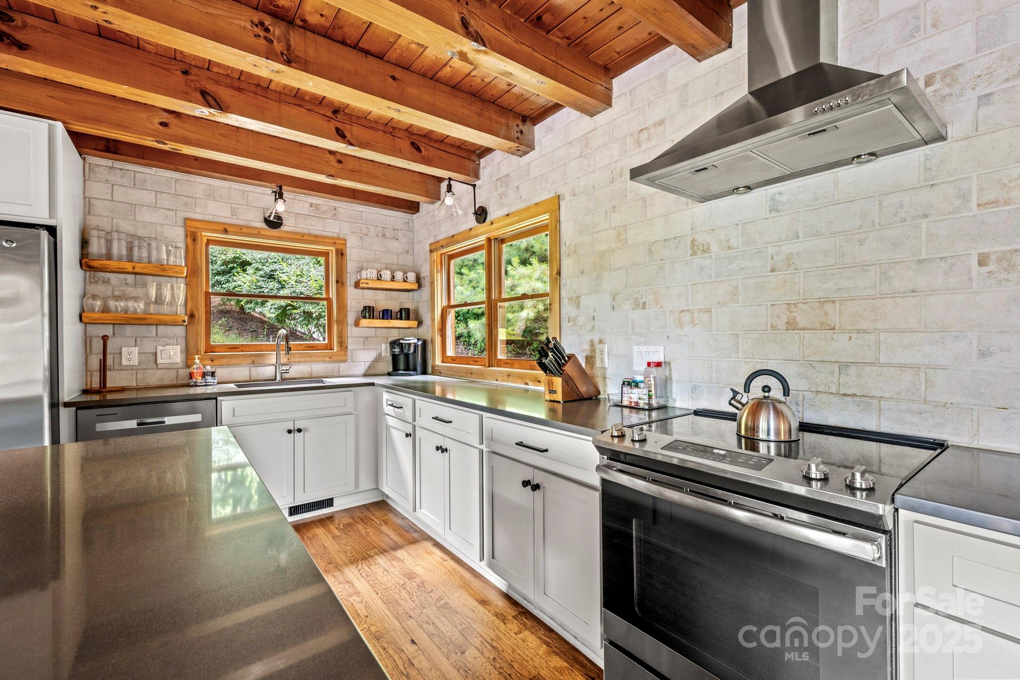1933 Laurel Ridge North Maggie Valley, NC 28751 - Photo 15 of 45 a kitchen with stainless steel appliances granite countertop a sink stove and cabinets