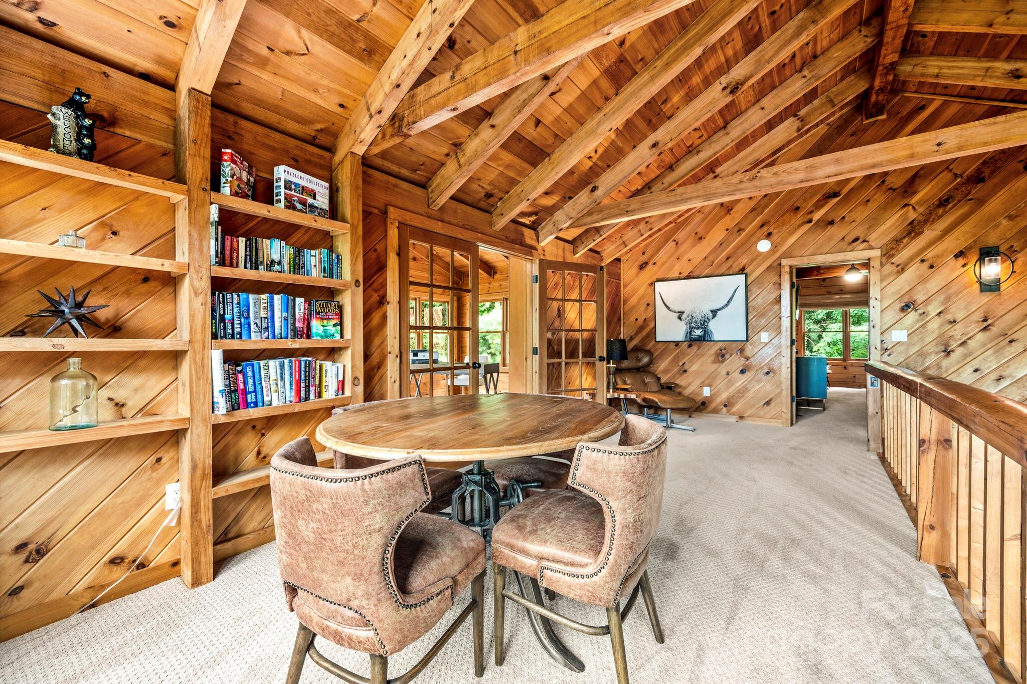 1933 Laurel Ridge North Maggie Valley, NC 28751 - Photo 25 of 45 a dining room with furniture and a floor to ceiling window