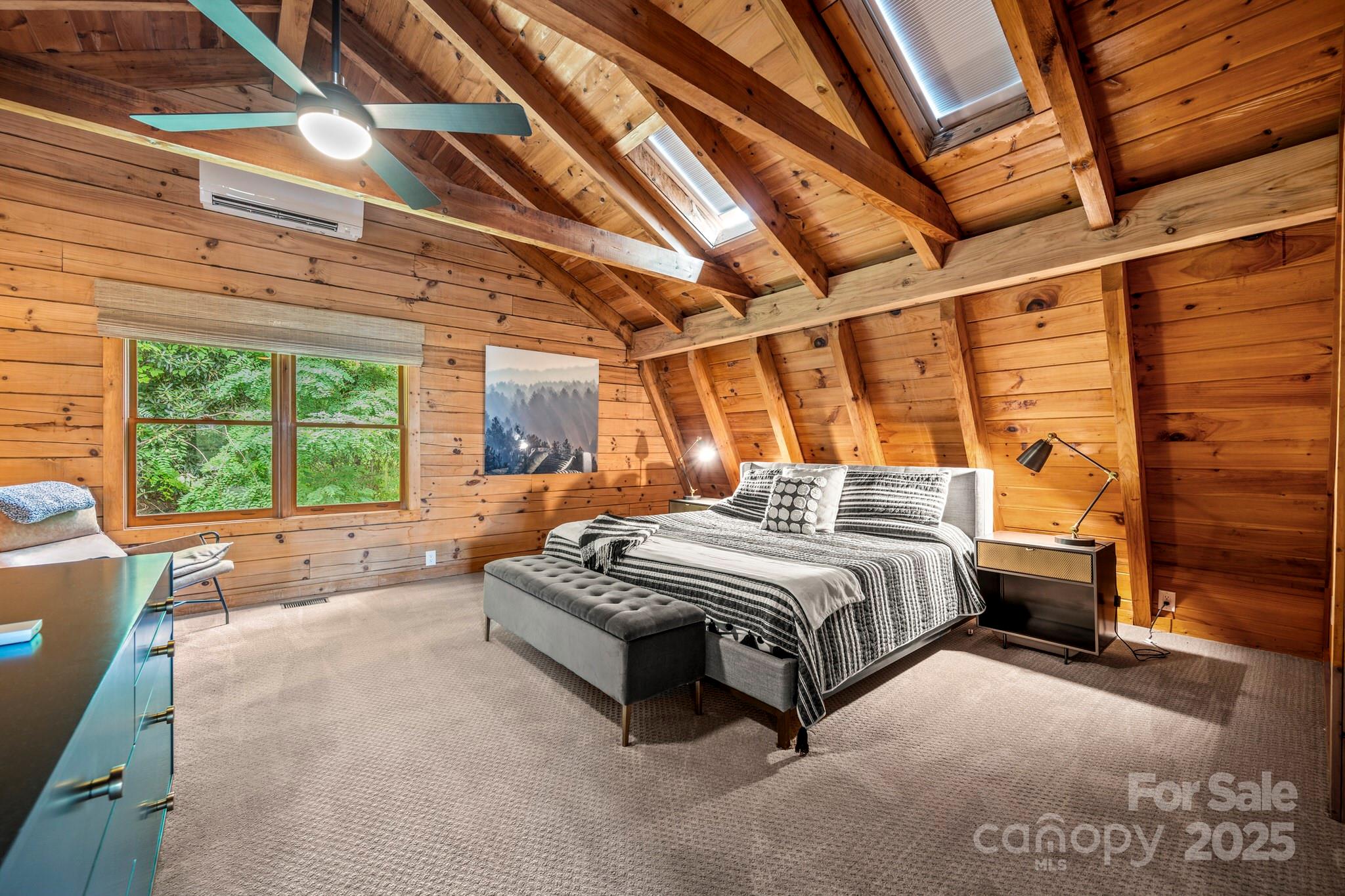 1933 Laurel Ridge North Maggie Valley, NC 28751 - Photo 34 of 45 a spacious bedroom with a bed and a large window