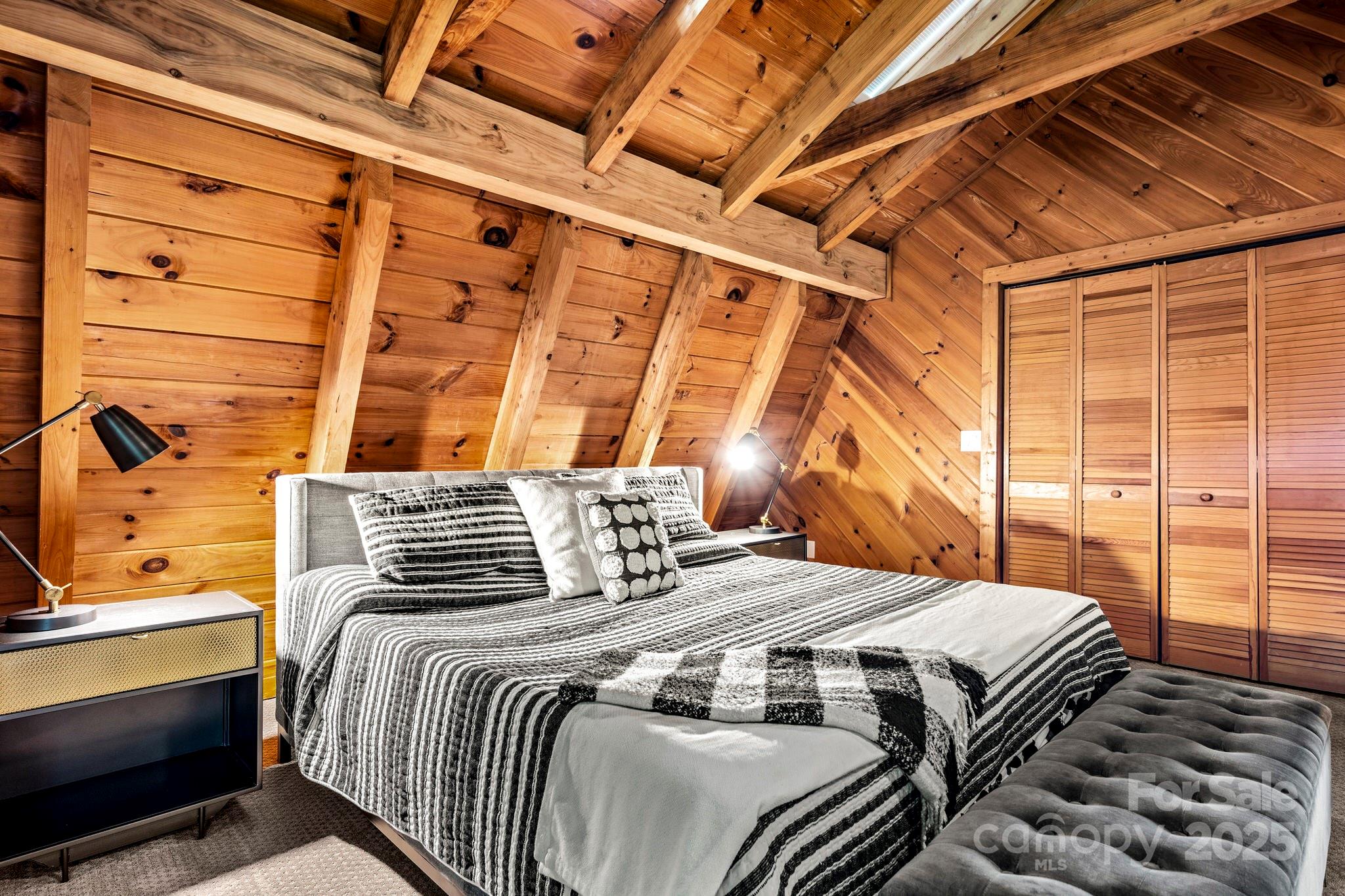 1933 Laurel Ridge North Maggie Valley, NC 28751 - Photo 36 of 45 a bedroom with a bed and wooden floor