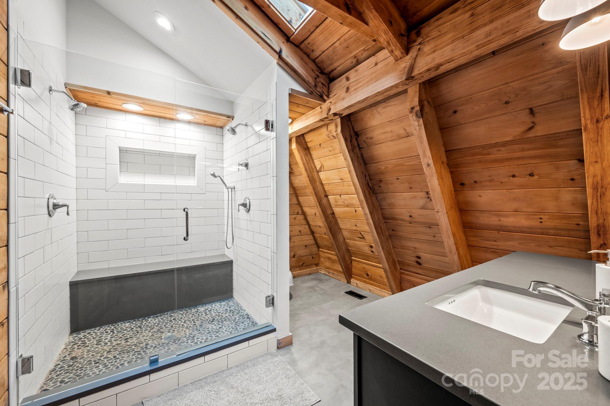 1933 Laurel Ridge North Maggie Valley, NC 28751 - Photo 37 of 45 a bathroom with a granite countertop sink a toilet and shower