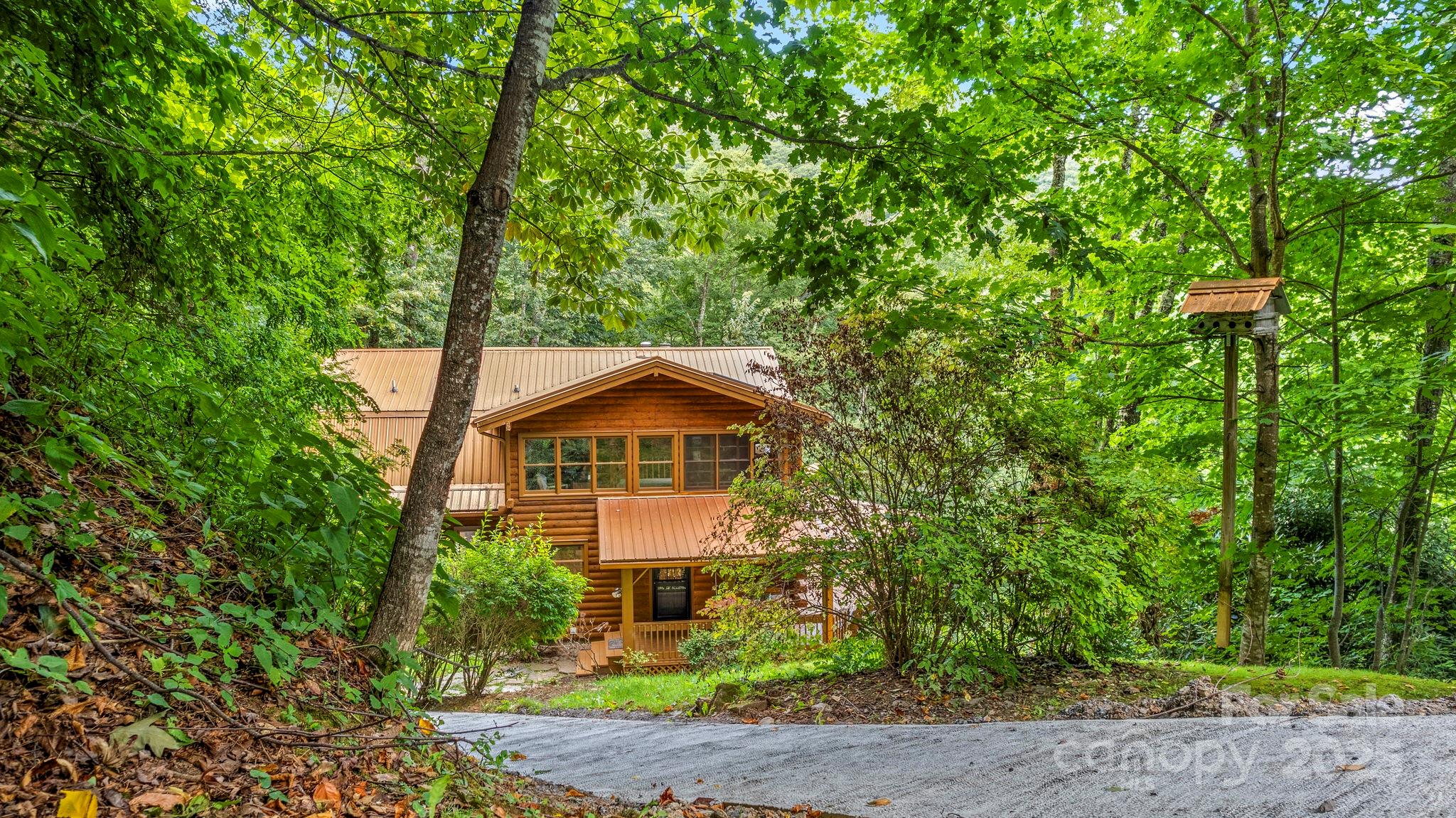 1933 Laurel Ridge North Maggie Valley, NC 28751 - Photo 10 of 45 a front view of a house with a yard and trees
