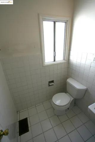 a kitchen with a refrigerator stove and white cabinets