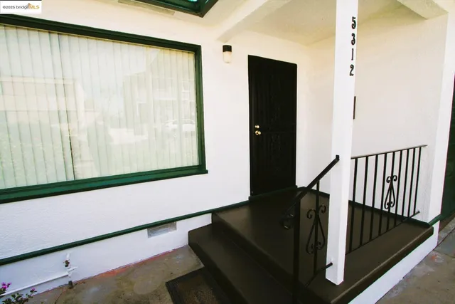 a view of balcony with wooden floor and potted plants