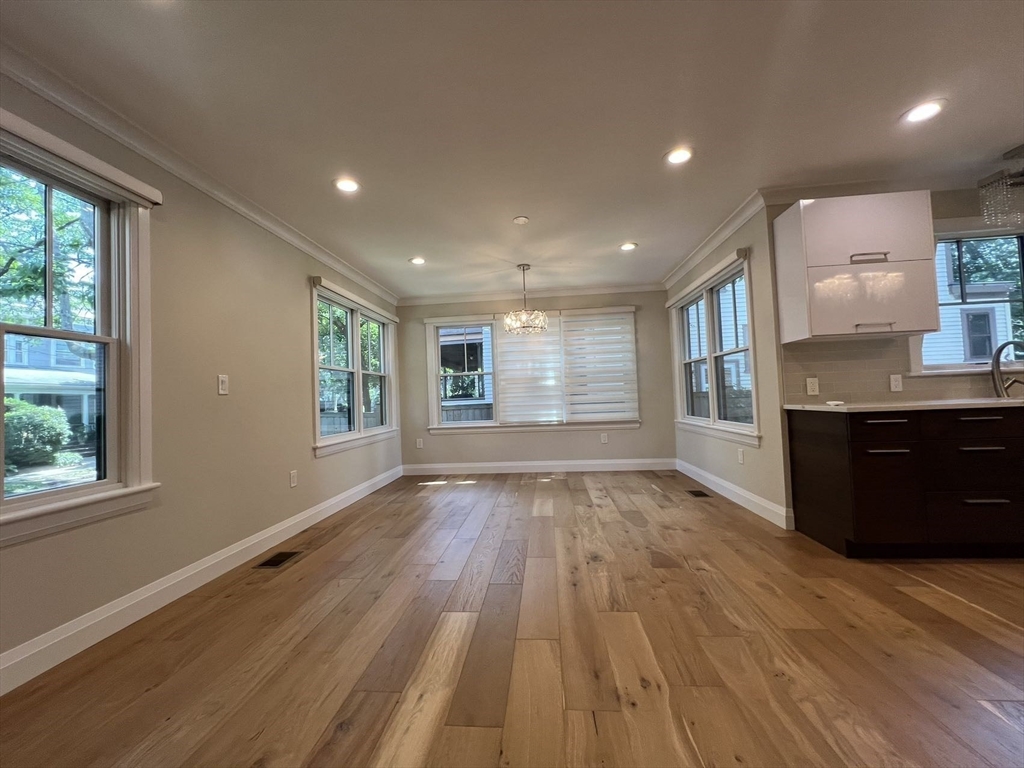 23 Winslow Road, Unit 1 Brookline, MA 02446 - Photo 2 of 27 a view of kitchen and hall with wooden floor