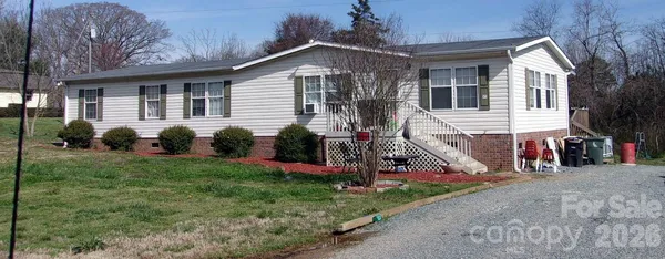a view of a house with a yard and a garden