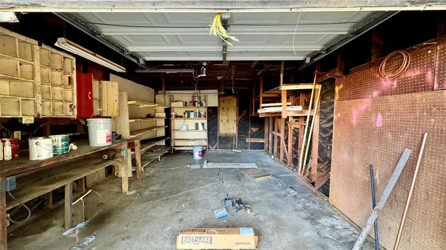 a view of backyard with large trees and a wooden fence