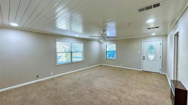 a view of an empty room with a chandelier