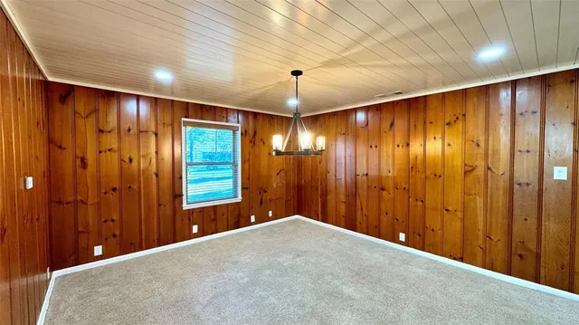 a view of a hallway with wooden shelves