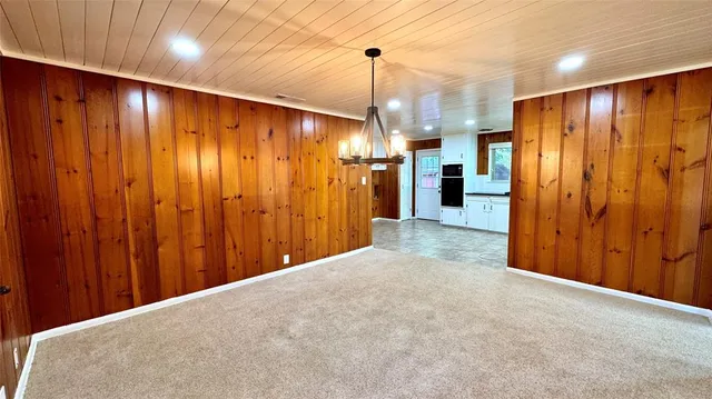 a view of a kitchen with refrigerator and kitchen view