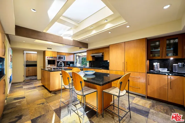 a bedroom with furniture and a large window