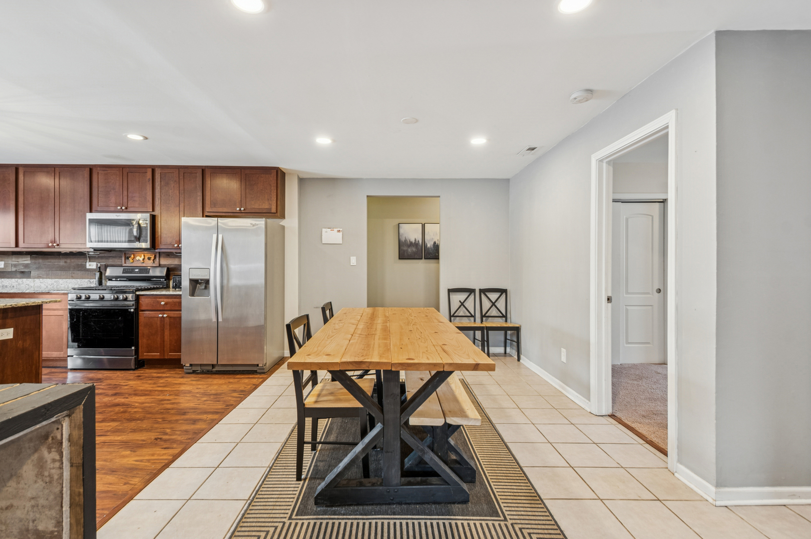 2113 Highwood Road McHenry, IL 60051 - Photo 7 of 18 a kitchen with stainless steel appliances kitchen island granite countertop a refrigerator and a stove top oven