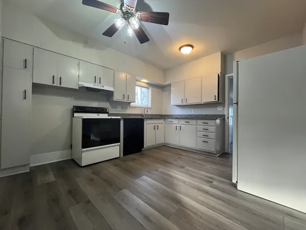 a kitchen with stainless steel appliances granite countertop a stove a sink and a refrigerator