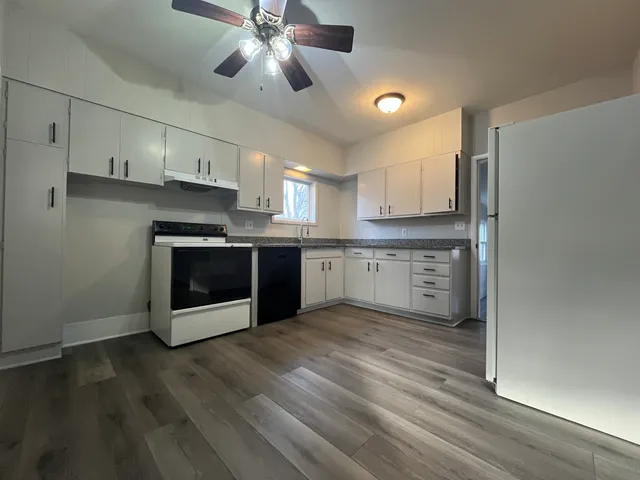 a kitchen with stainless steel appliances granite countertop a stove a sink and a refrigerator