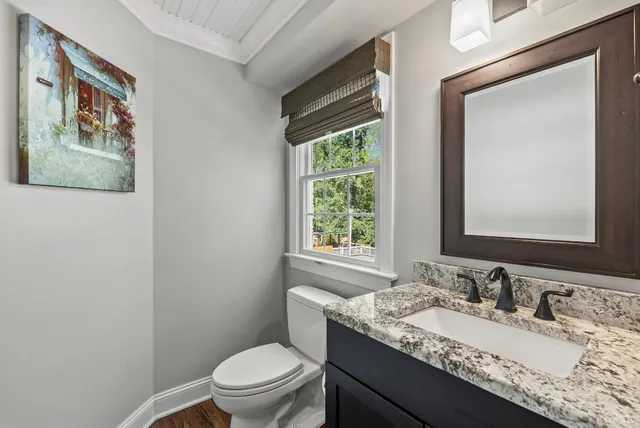 a living room with a fireplace a flat screen tv and a counter top