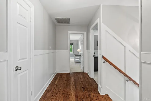 a living room with furniture a flat screen tv and a mirror