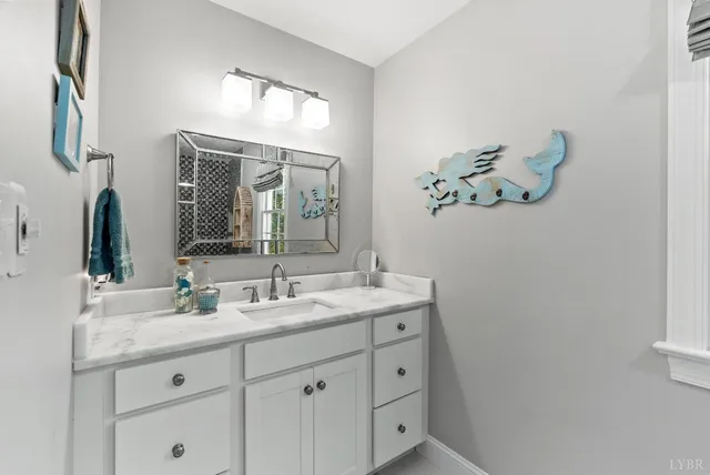 a view of hallway with furniture and wooden floor