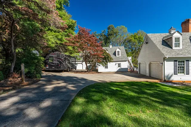 a living room with furniture a rug and a chandelier