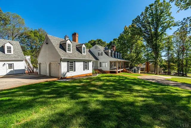 a view of a hallway to a livingroom with furniture and wooden floor