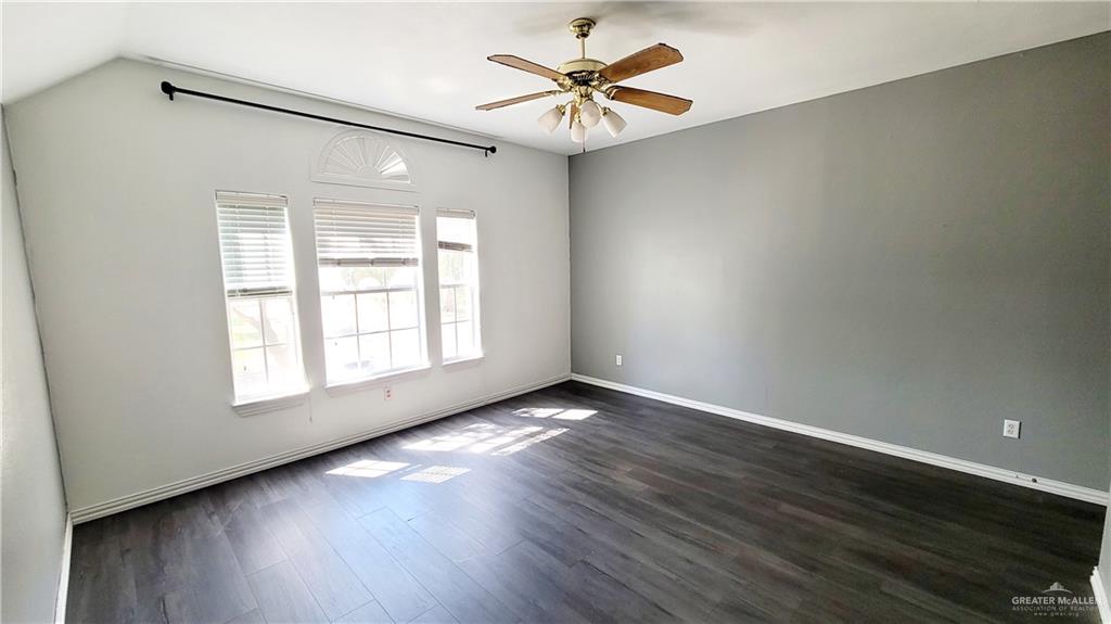 3003 El Jardin Street Mission, TX 78572 - Photo 20 of 25 an empty room with wooden floor and windows
