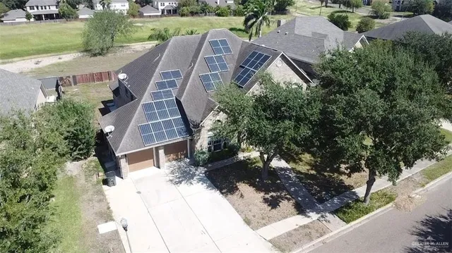 an aerial view of a house with outdoor space and street view